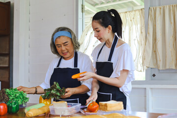 Happiness Asia family Mother and daughter eating healthy food in the kitchen.
