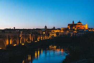 Sunset panoramic view of the Cathedral Mosque and the roman bridge of Cordoba, Andalusia Spain.