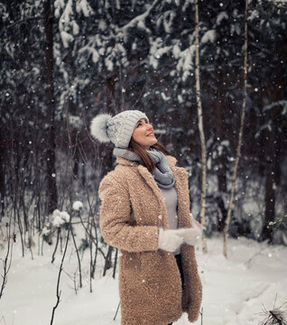 girl in winter hat with flying snow