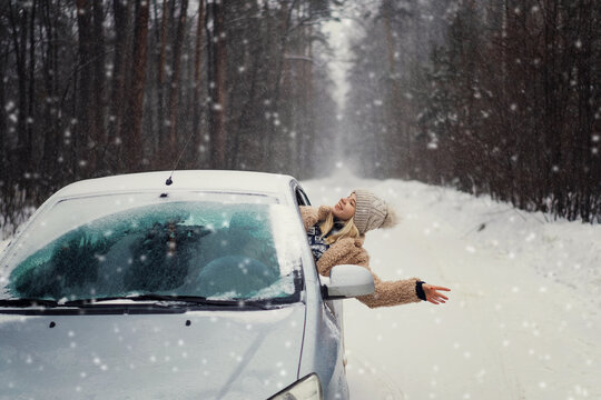 girl in winter hat with flying snow