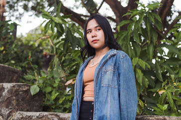 An annoyed young woman in deep thoughts. Wearing a casual outfit. Bothered by the gossips about...