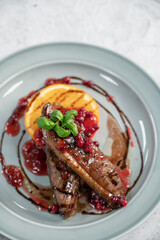 Tasty duck breast with orange and berries