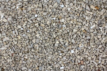 Dry gray gravel pebbles stones of medium fraction background texture