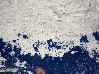 texture old concrete wall painted white and blue weathered cracks abstract background