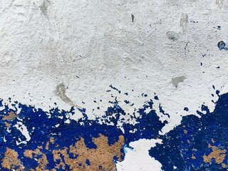 texture old concrete wall painted white and blue weathered cracks, abstract background