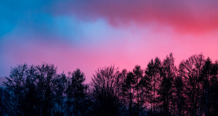 Fototapeta na wymiar Beautiful cloudy sunset sky glowing violet and pink