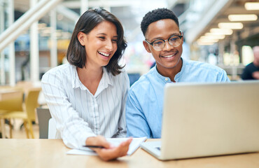 Its up to both of us to bring the results. Shot of a young businessman and businesswoman using a...