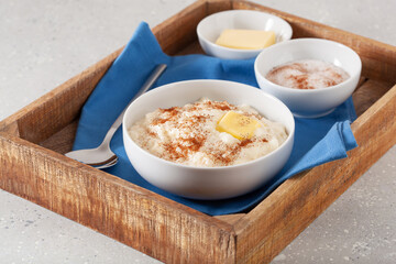 rice pudding with butter cinnamon. french riz au lait, norwegian risgrot, traditional breakfast dessert