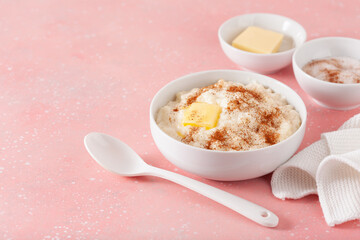 rice pudding with butter cinnamon. french riz au lait, norwegian risgrot, traditional breakfast dessert