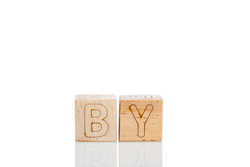 Wooden cubes with letters by on a white background