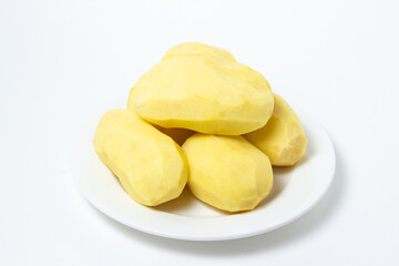 Peeled potatoes on a white background. Delicious and healthy vegetable. food preparation ingredient