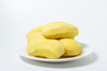 Peeled potatoes on a white background. Delicious and healthy vegetable. food preparation ingredient