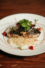 Grilled fish with couscous porridge and parsley
