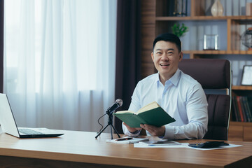 Asian freelancer records audio podcasts, businessman works in office, uses professional microphone...