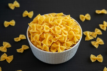 Raw Organic Farfalle Pasta in a Bowl, side view.
