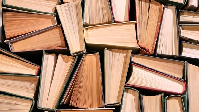 Lots of books on the table, spines up