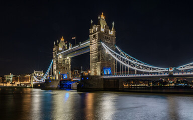 Fototapeta na wymiar Tower Bridge in London at night. A reflection of the bridge in the Thames