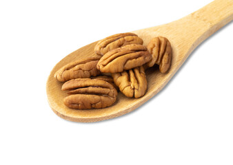 Pecan nuts on a spoon isolated over white background