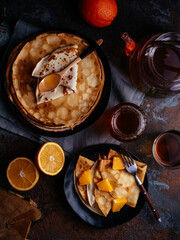 homemade pancakes in a black plate, tea