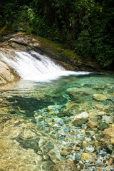 Beautiful view to green atlantic rainforest waterfall with blue water