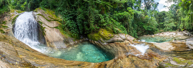 Beautiful view to green atlantic rainforest waterfall with blue water © Cavan