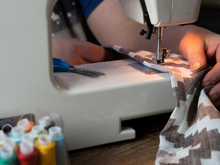 Close-up of the sewing process on a sewing machine. woman sewing curtains on a sewing machine