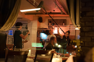 Behind scenes. Film crew team filming movie scene in restaurant - obrazy, fototapety, plakaty