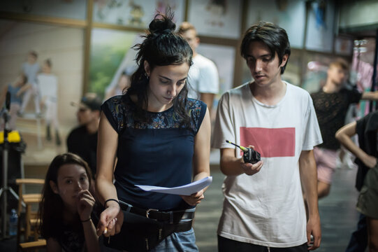 Behind Scenes. Film And Photography Director Checks Screenwriter Filming Scripts