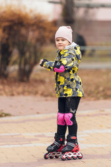 Cute little girl learning to roller skate