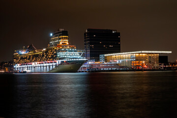 Fototapeta na wymiar Cruise ship in Amsterdam harbor in the Netherlands by night