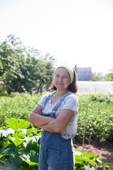 Elderly woman looking after her garden.