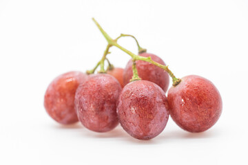 Bunch of red grapes , fresh with water drops. Isolated on white background.
