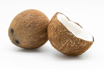 fresh whole and half coconut and slices isolated on white background