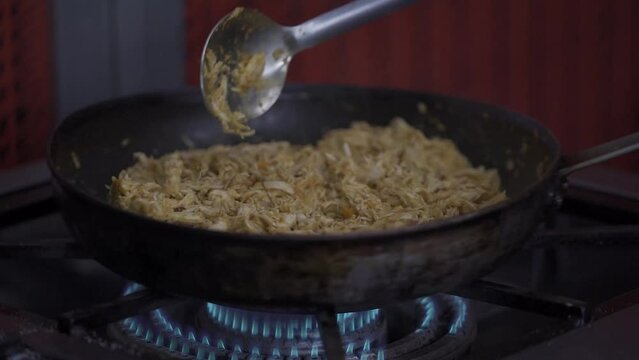 Cooking shredded chicken in the restaurant