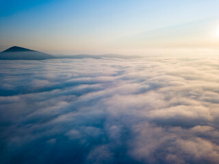 High flight above the clouds. Aerial drone view.