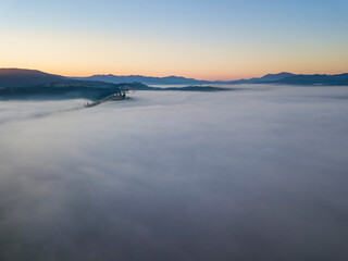 Sunrise over the fog in the Ukrainian Carpathians. Aerial drone view.