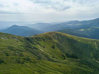 High mountains of the Ukrainian Carpathians in cloudy weather. Aerial drone view.