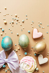 Fototapeta na wymiar Creative design for Easter with eggs and sweets. Stylish egg hunt concept with candy and decor
