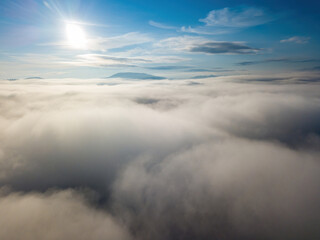 Obraz premium High flight above the clouds. Aerial drone view.
