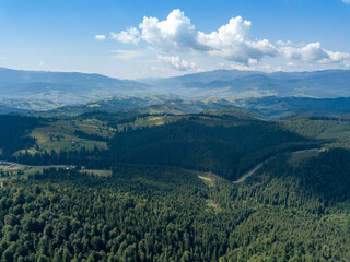 Fototapeta na wymiar Green mountains of Ukrainian Carpathians in summer. Sunny day. Aerial drone view.