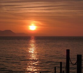 bright orange sunrise over the sea at Lyme Regis Dorset England