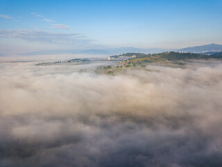 Naklejka na ściany i meble Morning fog in the Ukrainian Carpathians. Aerial drone view.