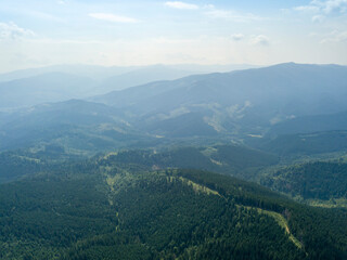 Fototapeta na wymiar Green mountains of Ukrainian Carpathians in summer. Sunny day, rare clouds. Aerial drone view.