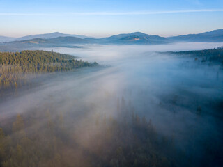 Morning mist in Ukrainian Carpathian mountains. Aerial drone view.