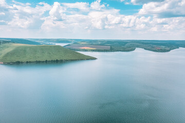 Magnificent aerial view on small tributary of the Dniester River with picturesque shores. National Nature Park Podilski Tovtry, the Dniester River, Ukraine. Beautiful view from flying drone.