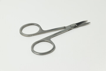 metal manicure scissors on a white background
