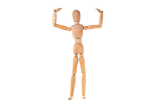 a wooden man stands with his arms raised to the sides isolated on a white background