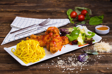 Fried chicken and pasta with sauce, prepared with special ingredients