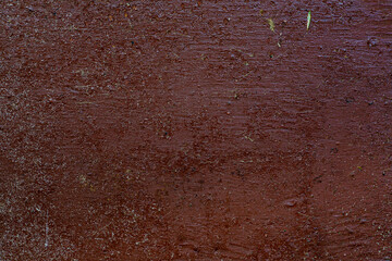 Scratches, sand, cracks abstract texture background. An old shabby red surface with lots of scratches, sand, dust and peeling paint.