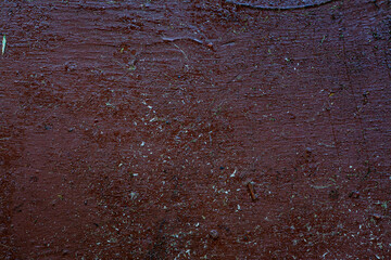 Scratches, sand, cracks abstract texture background. An old shabby red surface with lots of scratches, sand, dust and peeling paint.